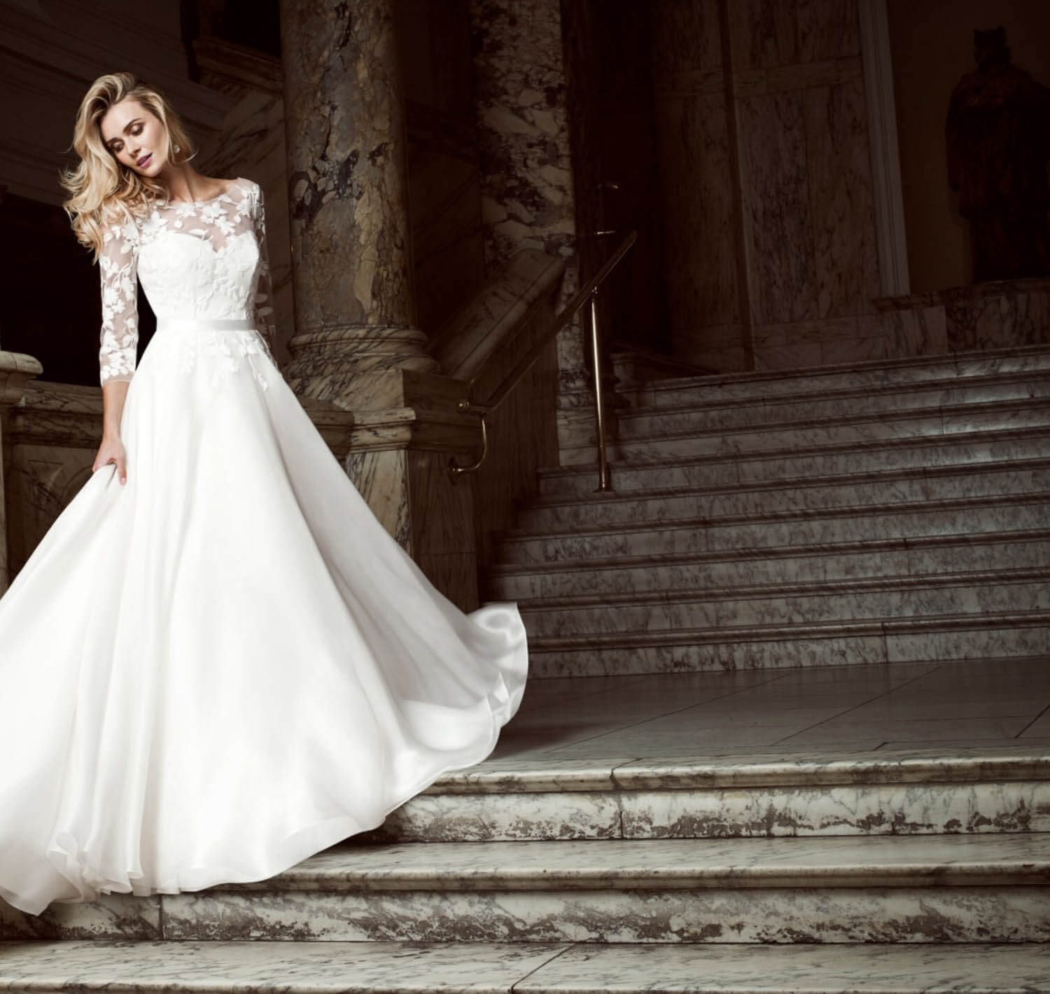 Model wearing a white gown. Mobile image