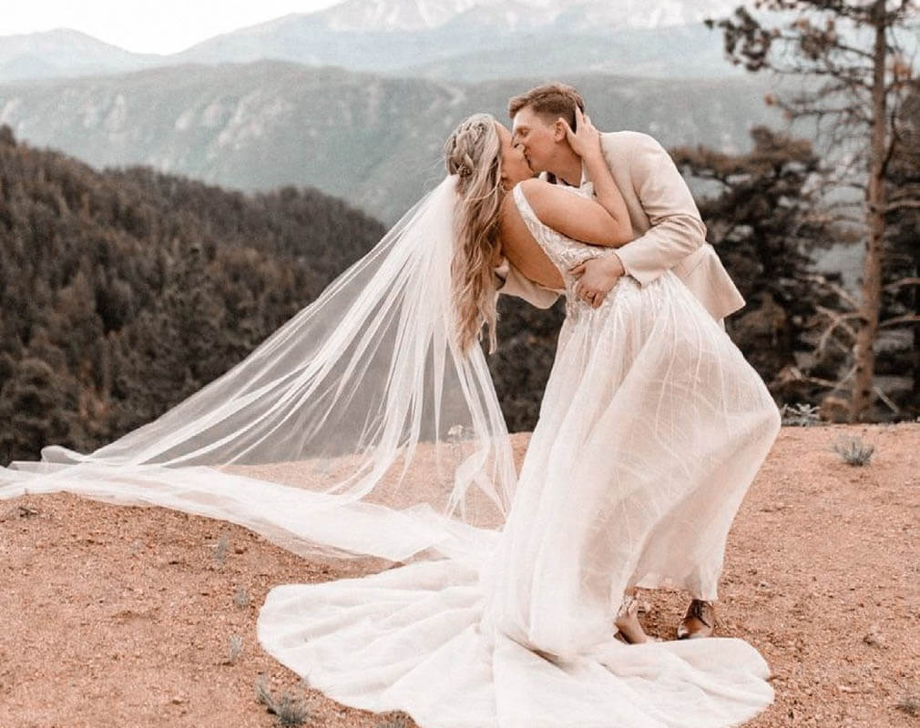 Сouple wearing a white gown and a white suit